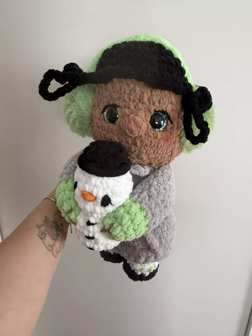Handmade Crochet Doll with Green Ear Muffs and Snowman thumbnail