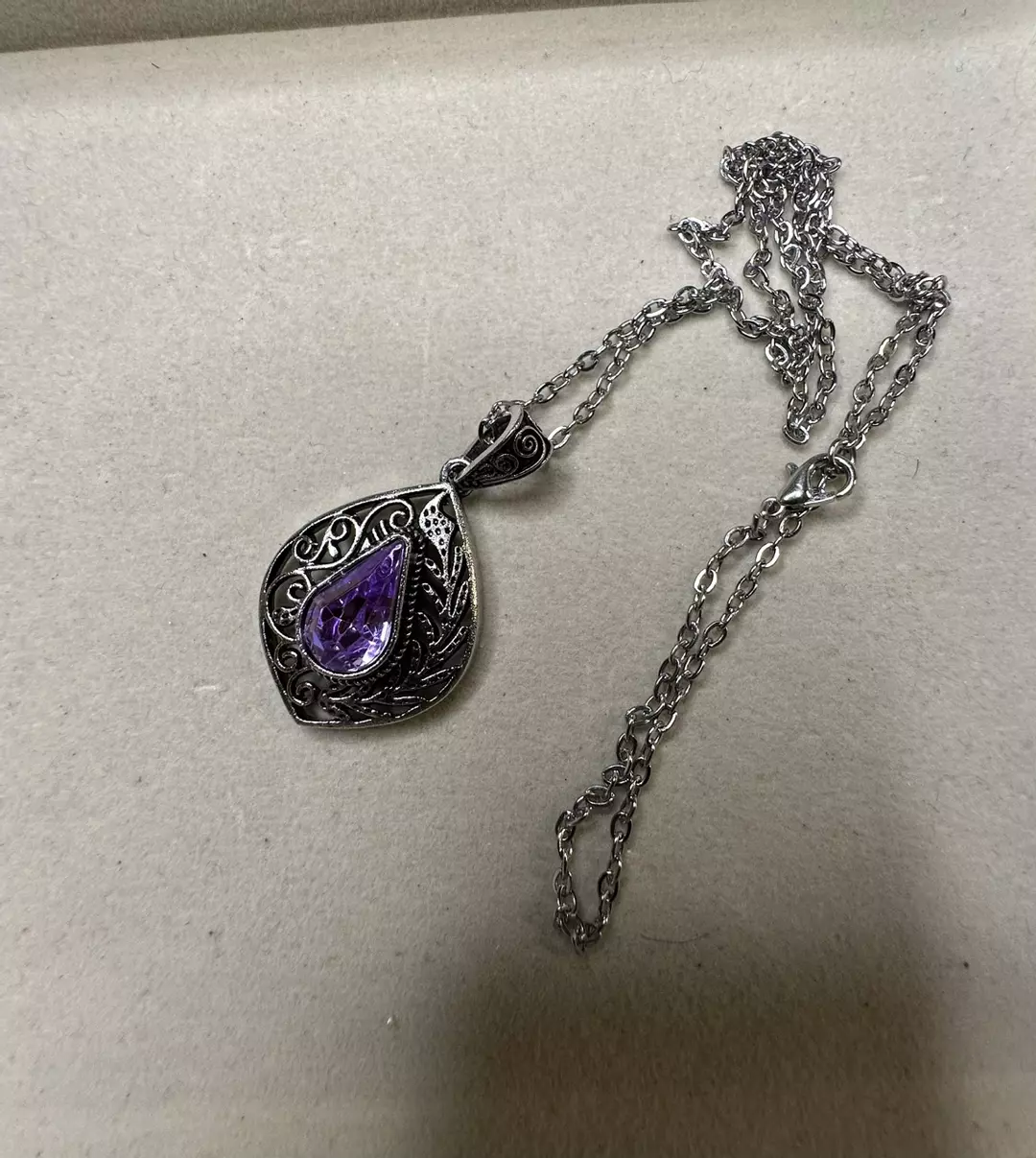 Silver tone necklace with purple stone thumbnail